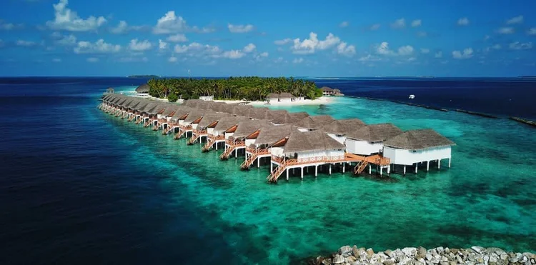 Maldives resort villas over turquoise water